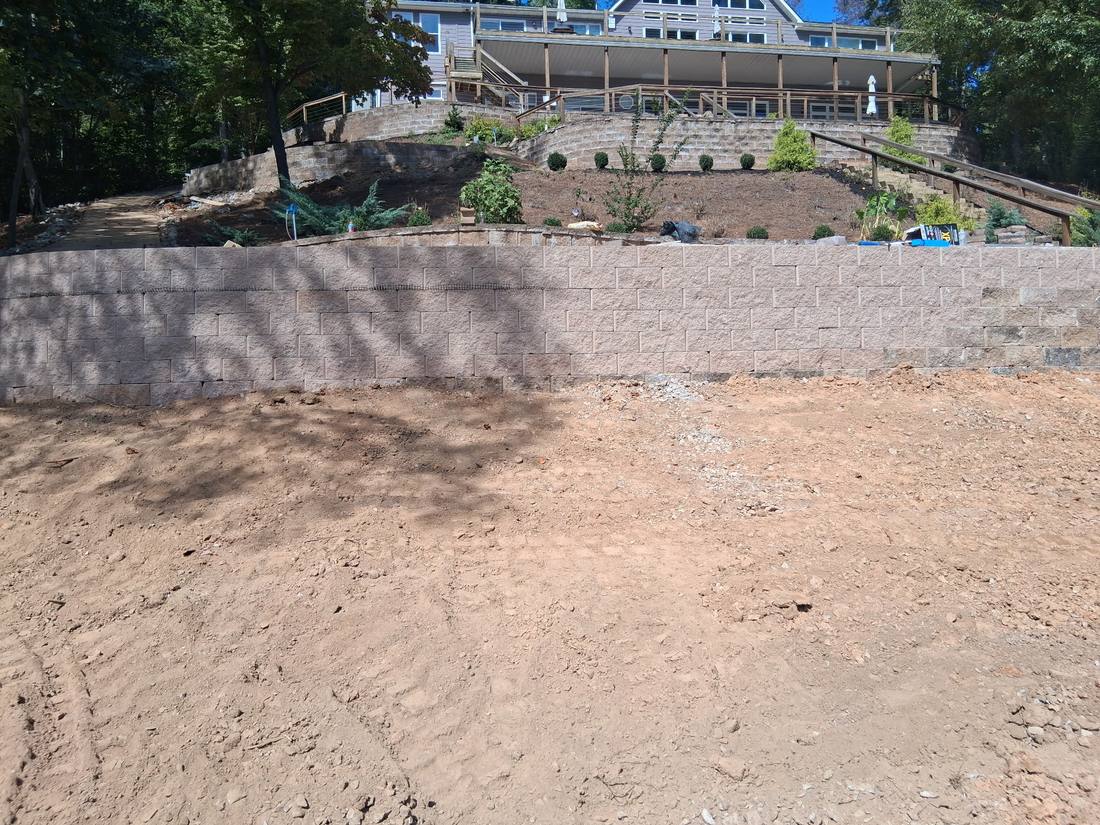Finished stone retaining wall and graded yard on a Campbell County, TN property